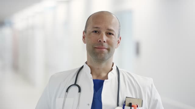 Portrait of confident mature doctor at hospital