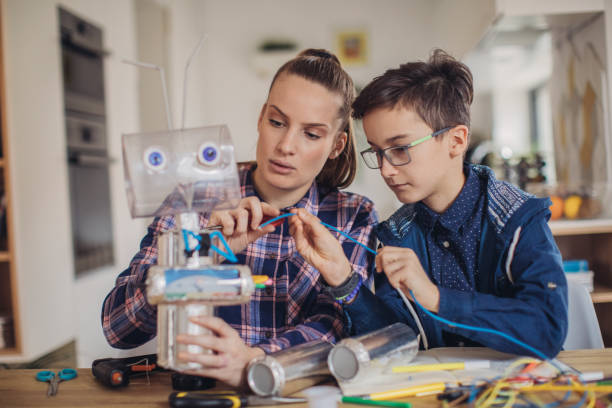 istock Little boy making toy of recycling material for school project 1135769994