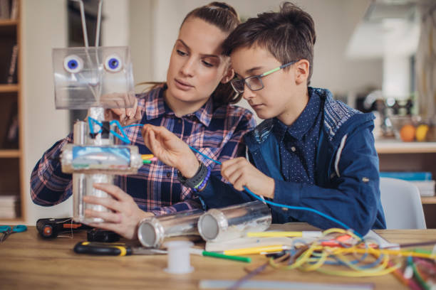 istock Little boy making toy of recycling material for school project 1135770020