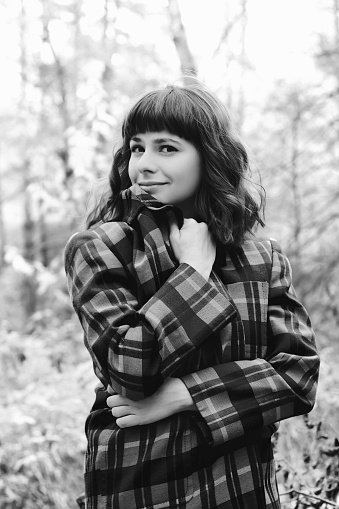 Portrait of an attractive young woman outdoor. Black and white photo.