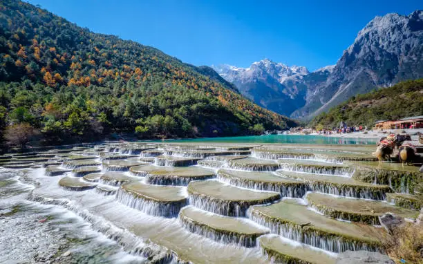 The unqiue fan-shaped stairs of Blue Moon Valley with Jade Dragon Snow Mountain in the background
