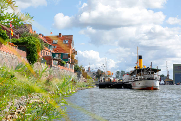 Historic harbor with half-timbered houses and flat bottom boat at the old town of Stade, Lower Saxony, Germany