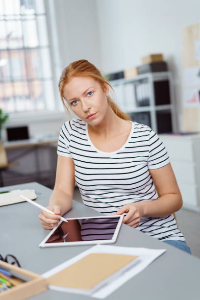 istock Thoughtful businesswoman working with a tablet 1135771645