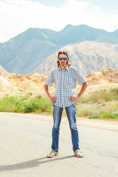 istock the guy standing on a background of mountains 1135772093