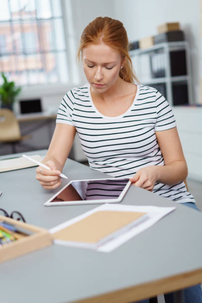 istock Serious young woman working in a design studio 1135773460