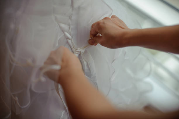 istock Bridesmaid tie up wedding dress for bride 1135773920