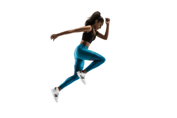 istock Young african woman running or jogging isolated on white studio background. 1135775375