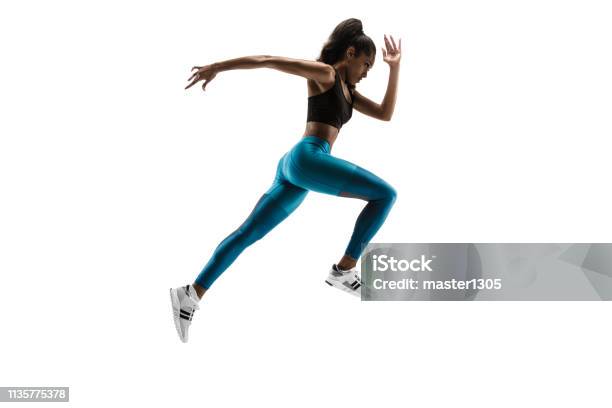 Young African Woman Running Or Jogging Isolated On White Studio Background Stock Photo - Download Image Now