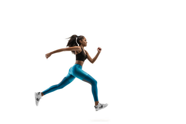 istock Young african woman running or jogging isolated on white studio background. 1135775379