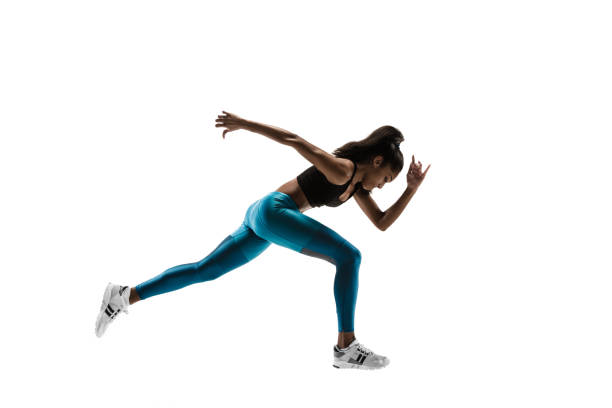 istock Young african woman running or jogging isolated on white studio background. 1135775380