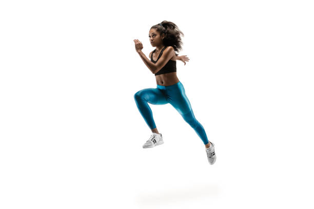 istock Young african woman running or jogging isolated on white studio background. 1135775384