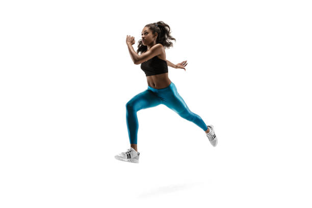 istock Young african woman running or jogging isolated on white studio background. 1135775385