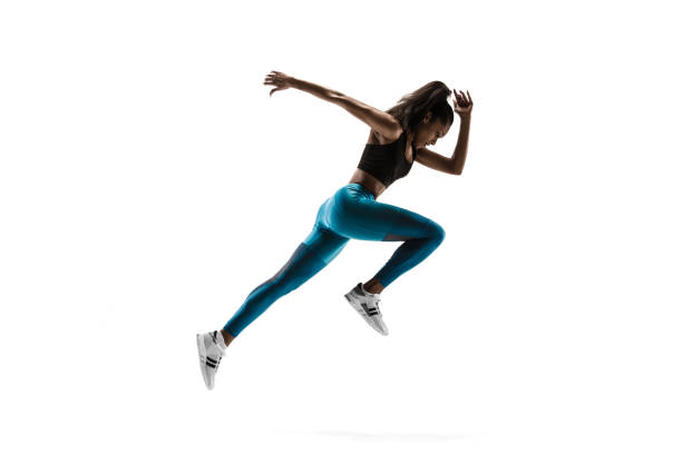 istock Young african woman running or jogging isolated on white studio background. 1135775389