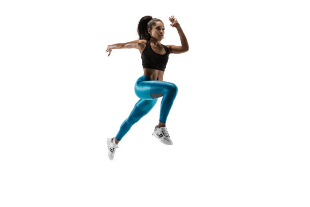 istock Young african woman running or jogging isolated on white studio background. 1135775390