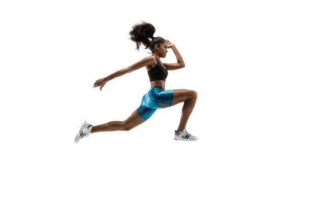 istock Young african woman running or jogging isolated on white studio background. 1135775392
