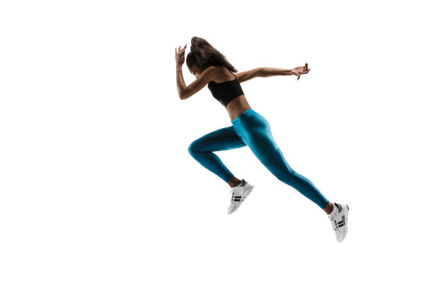 istock Young african woman running or jogging isolated on white studio background. 1135775399