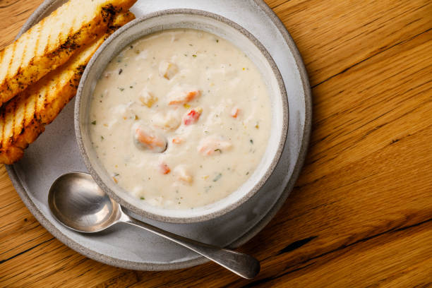 istock Boston Chowder Soup with Seafood on wooden background copy space 1135775789