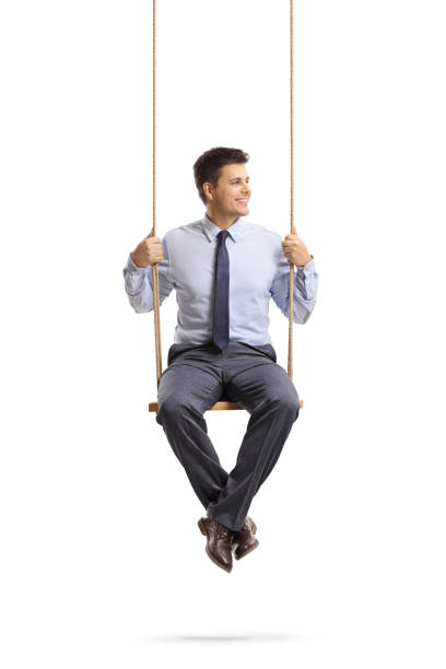 istock Young professional man sitting on a swing and looking away 1135776939