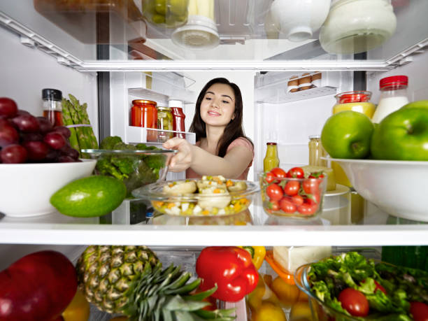 istock Woman taking vegetables from a fridge 1135777058