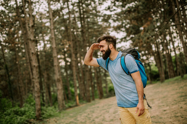 istock Active healthy man hiking in beautiful forest 1135777774