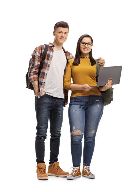 istock Male and female student standing and holding a laptop computer 1135778020