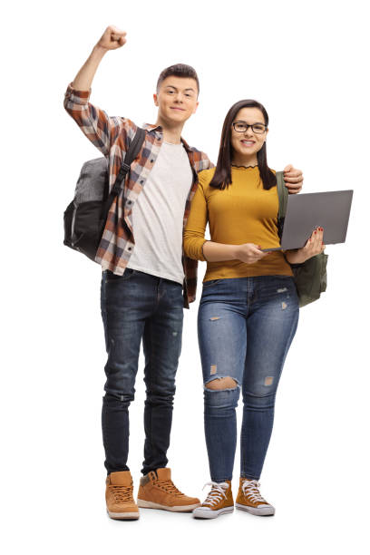 istock Happy male student embracing a female student standing and holding a laptop computer 1135778212