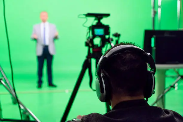 Camera operators working on backstage in green box studio