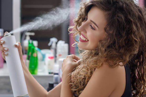 istock View from side of woman using hairspray for fixation 1135784003