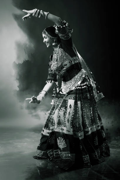 istock Young Indian Lady Performing Cultural Dance 1135785523