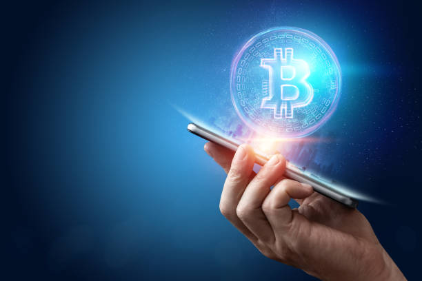 istock Male hand, bitcoin hologram, ultraviolet creative background. Cryptocurrency, electronic money, blockchain technology, finance, copy space. 1135785664
