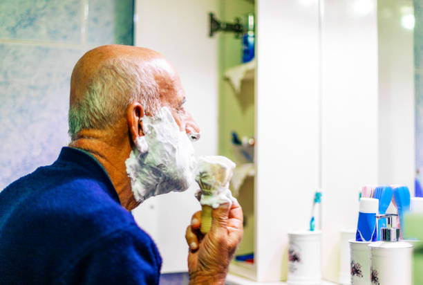 Seniorman shaving at home