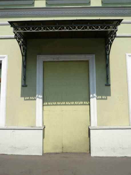istock old yellow wall with door shape 1135788820