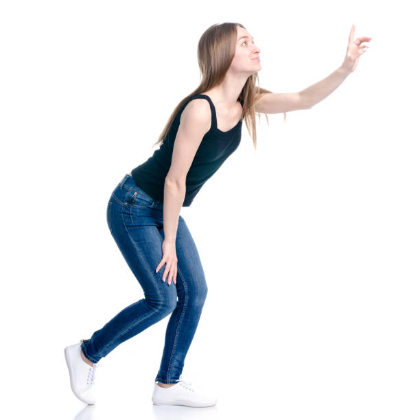 istock Woman in jeans standing showing pointing 1135788856