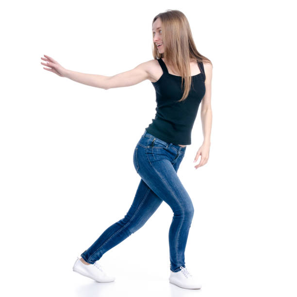 istock Woman in jeans standing showing pointing holding 1135788859