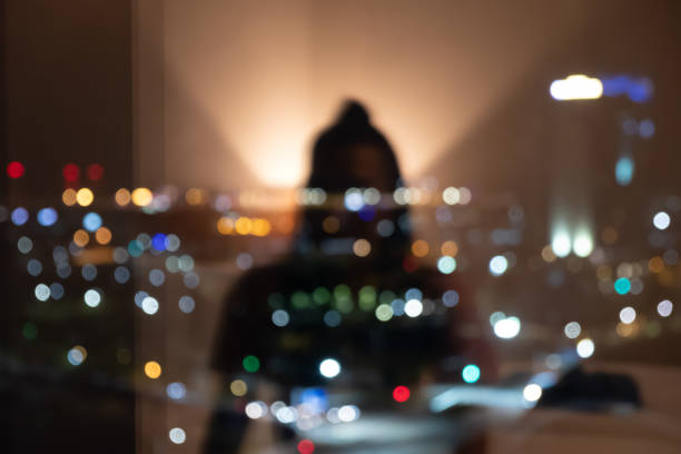 riflesso di una ragazza dalla finestra contro le luci della città - blurred motion circle reflection illuminated foto e immagini stock