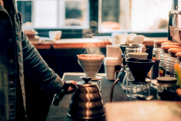 Barista brewing coffee in authentic coffee shop