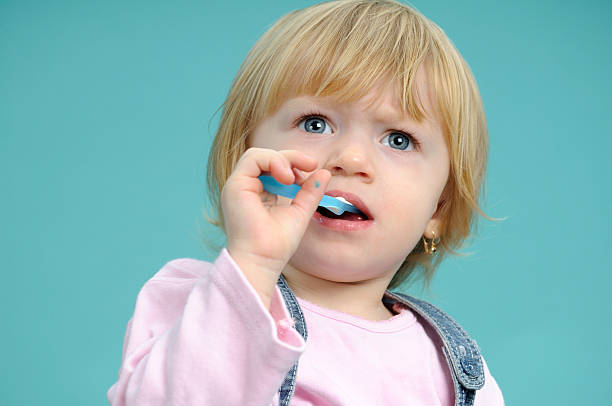 istock baby girl brushing teeth 113578959