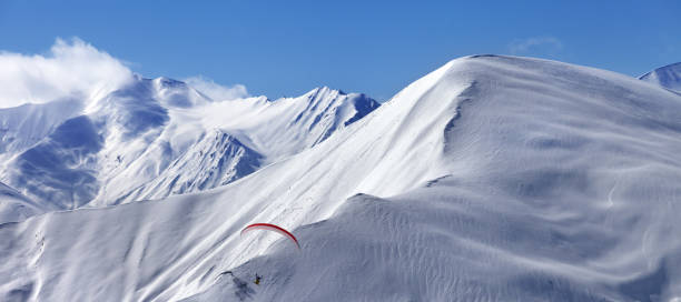 istock Speed flying in snowy winter mountains 1135789861