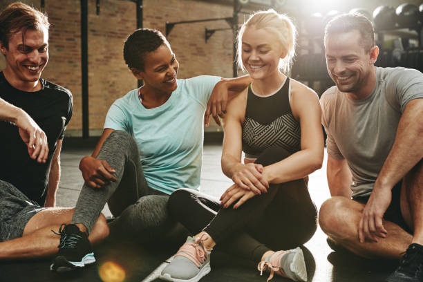istock Smiling friends sitting and talking together after a gym workout 1135790177