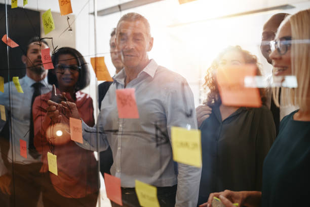 istock Mature manager and his team having a brainstorming session together 1135790281