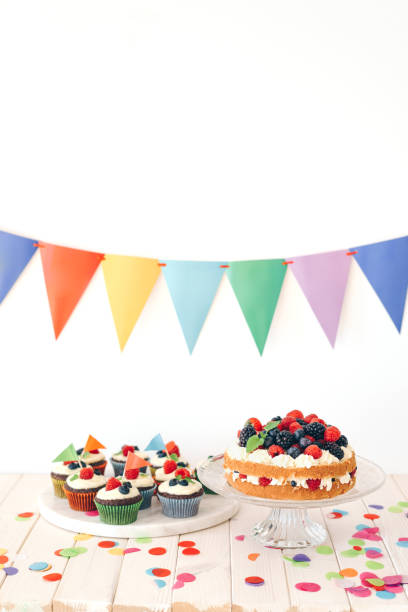 istock Berry cake and chocolate cupcakes with colourful confetti and bunting 1135791929