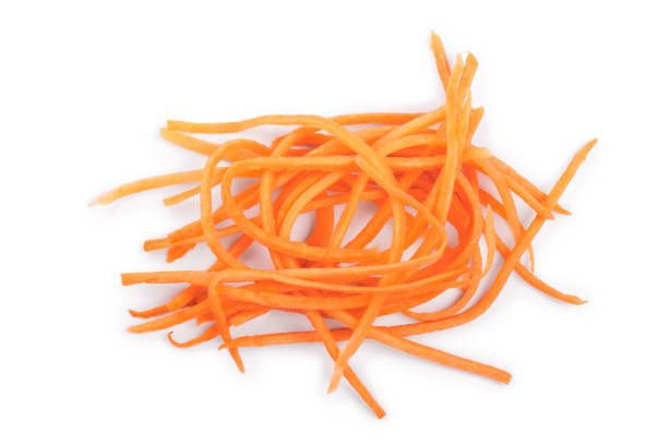 istock fresh shredded carrots isolated on white background, Top view. Flat lay 1135792026