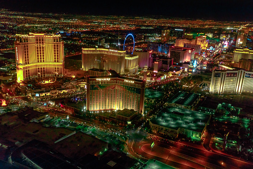 Las Vegas, Nevada, United States - August 18, 2018: aerial view from scenic flight of Las Vegas Strip by night. The Mirage, The Venetian, The Palazzo, Treasure Island, High Roller Ferris Wheel