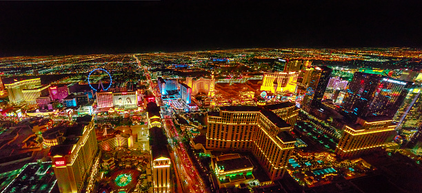 Las Vegas, Nevada, United States - August 18, 2018: aerial panorama of Las Vegas Strip by night. Scenic flight over High Roller, Caesars Palace, The Paris, Planet Hollywood, Bellagio Casino and Hotel