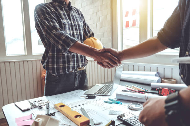 istock Engineer and contractor shaking hands success of the project work together. 1135793095