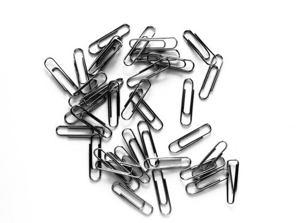 Paper clips on white background in office