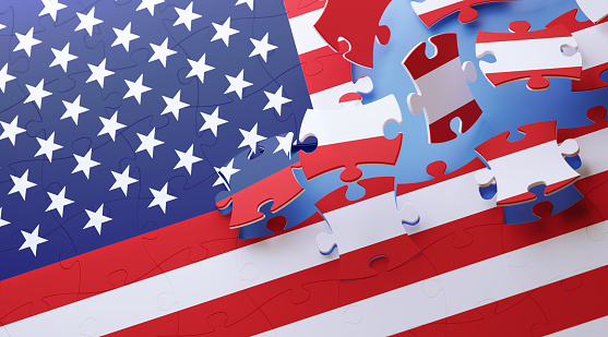 Jigsaw puzzle pieces forming American flag on blue background. Horizontal composition with copy space. Great use for puzzle concepts.