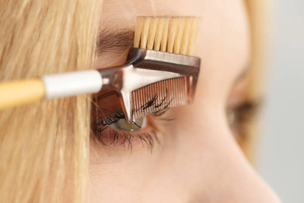 istock Woman brushing her eyelashes 1135793685