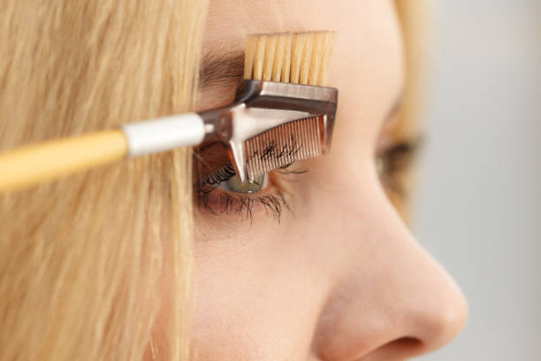 istock Woman brushing her eyelashes 1135793703