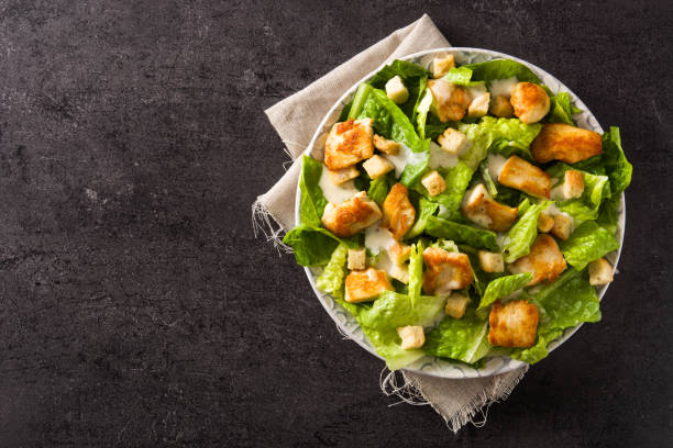 istock Caesar salad with lettuce,chicken and croutons 1135794356
